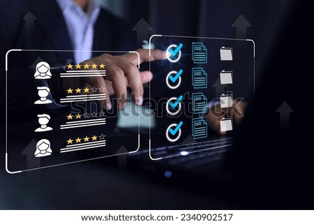 Businessman click blue check mark on laptop screen to vendor evaluate or supplier feedback industrial facility and rated a maximum of five stars according to the ISO documentation management system. Royalty-Free Stock Photo #2340902517