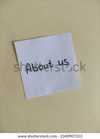 paper note with the words About us

