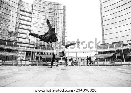 young boy performing parkour move in the center of Milan. concept about recreation and leisure