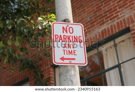 No Parking sign on a city street, representing order, restriction, and urban regulations. Symbolizes vehicular control and maintaining orderly spaces