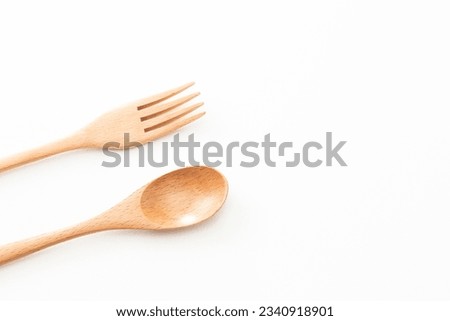 Wooden cutlery on white background.