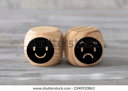 Happiness  and sadness concept. Two abstract geometric wooden dice isolate on white rustic surface. Antagonism concept.