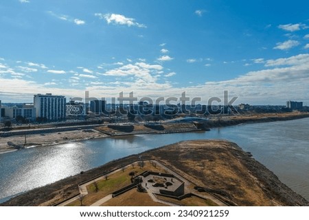 a stunning aerial shot of flowing waters of Wolf Creek Harbor with skyscrapers and buildings in the skyline of the city with blue sky and clouds at Mud Island in Memphis Tennessee USA