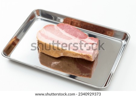Block bacon on the cooking tray.