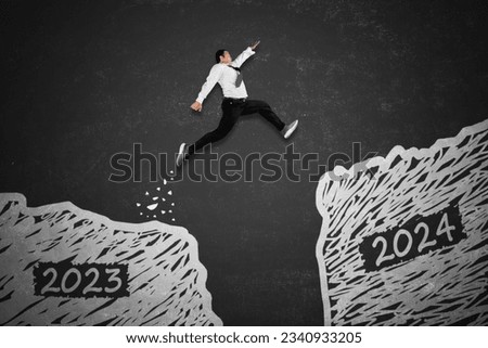 New year concept. Asian businessman jumping gap on the blackboard from 2023 numbers to 2024 new year numbers