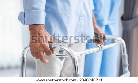Amyotrophic lateral sclerosis sufferer being helped by a physiotherapist. Royalty-Free Stock Photo #2340940201