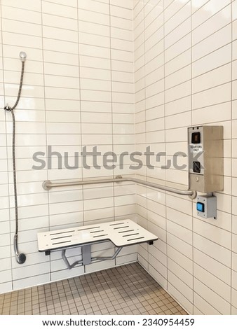 A public shower room in the environmental conservation park, with one specifically designed and designated for use by disabled individuals.