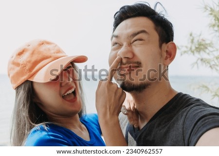 Funny and cheerful selfie portrait of asian couple lover.