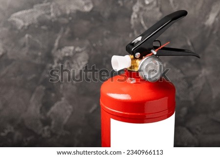 Fire extinguisher on black texture background. Fire protection, home fire extinguisher. home security concept. Place for text. Copy space.banner