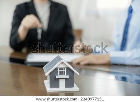 Real estate agents offer sale home insurance and close the sale immediately after the customer signs a purchase contract under a formal agreement. Real Estate Home insurance concept.