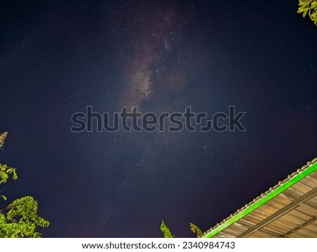 The Milky Way Galaxy above people's houses. Mobile Astrophotography