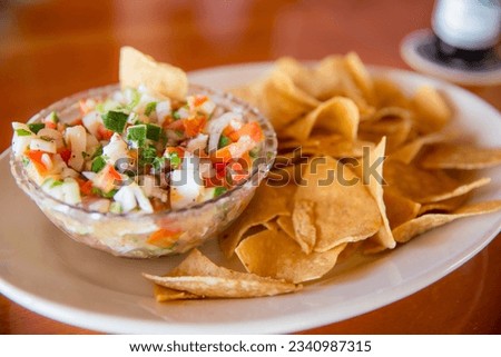 Conch Ceviche with Chips as an appetizer Royalty-Free Stock Photo #2340987315