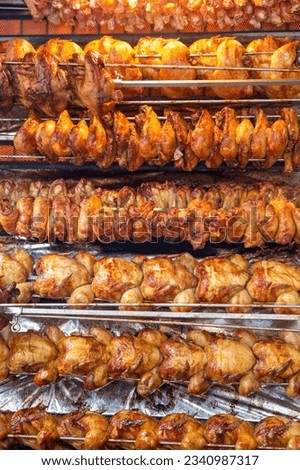 Rotisserie chicken on a rack roasting