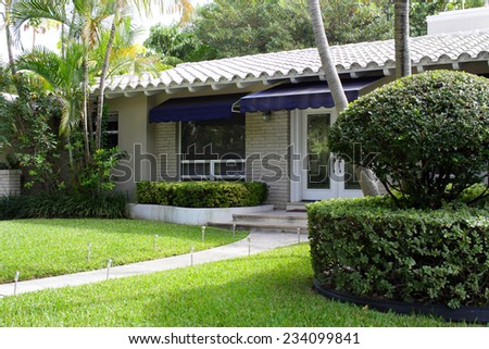 Photo of a home with hedges and bushes
