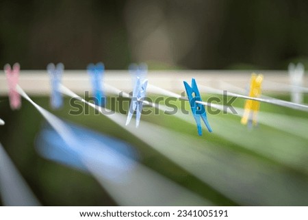 colored pegs on clothes line outside of a house in australia