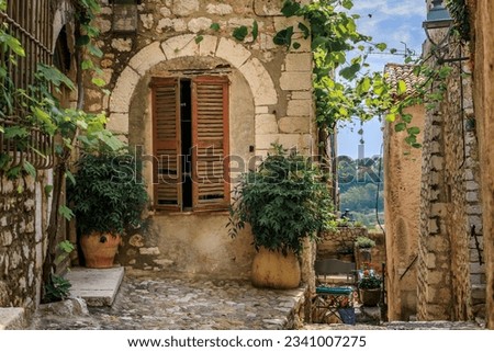 Traditional old stone houses on a street in the medieval town of Saint Paul de Vence, French Riviera, South of France Royalty-Free Stock Photo #2341007275