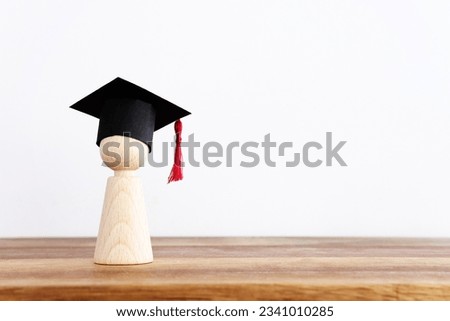 Image of education concept. Wooden people figure with graduation hat