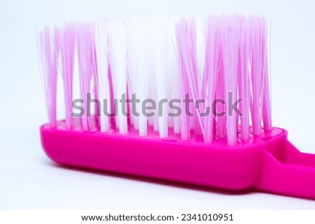 Close-up of a pink brush on a white background