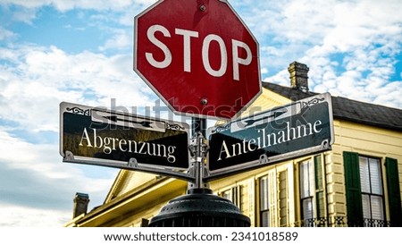 An image with a signpost pointing in two different directions in German. One direction points towards participation, the other points towards differentiation. Royalty-Free Stock Photo #2341018589