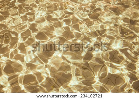 Patterned gold surface water in the pool.