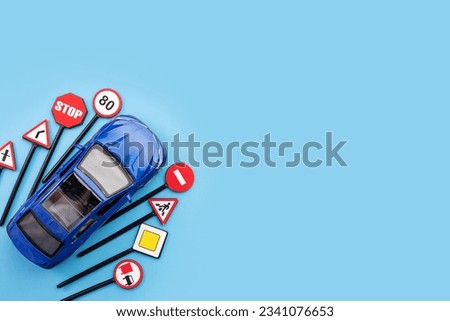 driving lessons and educational courses on traffic laws and driving skills, car and road signs on a blue background, copy space