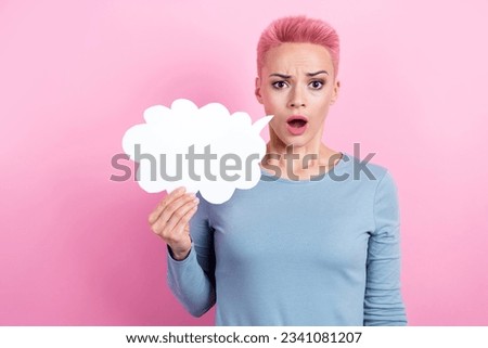 Photo of confused offended girl with short hair dressed blue sweatshirt holding mind cloud staring isolated on pink color background