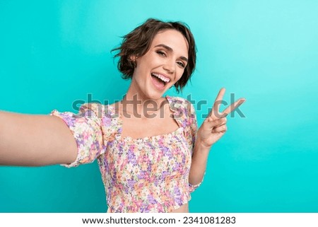 Portrait of positive gorgeous person beaming smile take selfie arm fingers demonstrate v-sign isolated on turquoise color background Royalty-Free Stock Photo #2341081283