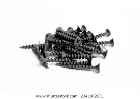 Bunch Of Black Metallic Screws Fastening Items Bolts Nuts Nails Closeup Photo On White Background