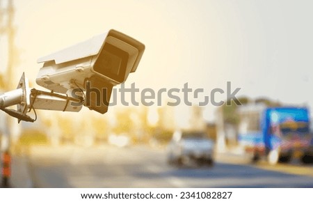 CCTV cameras installed over the rural road, blurred road background, concept for security of transportation by monitoring through CCTV cameras and mobile  devices to safe human life. Royalty-Free Stock Photo #2341082827