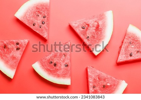 Juicy watermelon slices on a vibrant red background, a refreshing summer treat. Flat lay