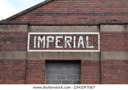 White Brick Factory Sign in Wall of Old Industrial Building 