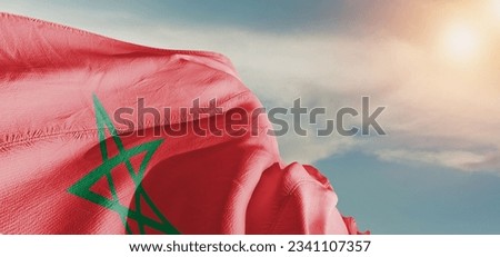 Morocco national flag cloth fabric waving on beautiful sky Background. Royalty-Free Stock Photo #2341107357