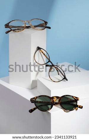 Sunglasses and glasses sale concept. Trendy sunglasses background. Trendy Fashion summer accessories. Copy space for text. Summer sale. Optic store discount poster. glasses with rounded frames. Royalty-Free Stock Photo #2341133921