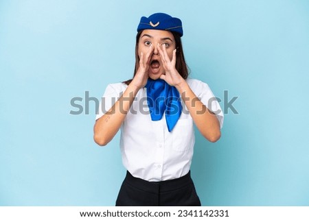 Airplane stewardess caucasian woman isolated on blue background shouting and announcing something