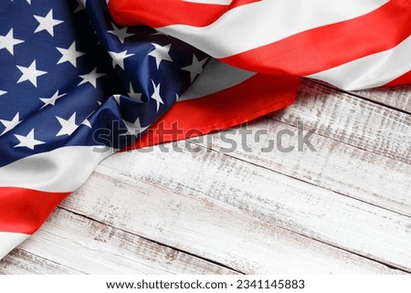 Stars and stripes american flag on rustic wooden background, top view, copy space. The pride of the American people. Symbol of independence, freedom and patriotism in the USA