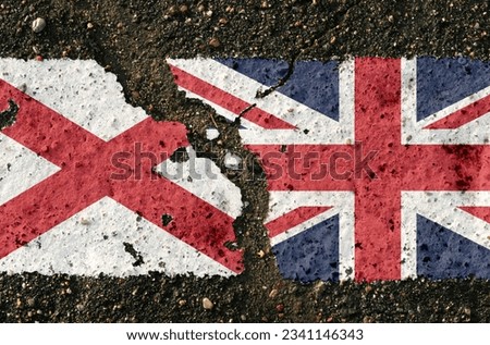 On the pavement are images of the flags of Northern Ireland and UK, as a symbol of confrontation. Conceptual image.