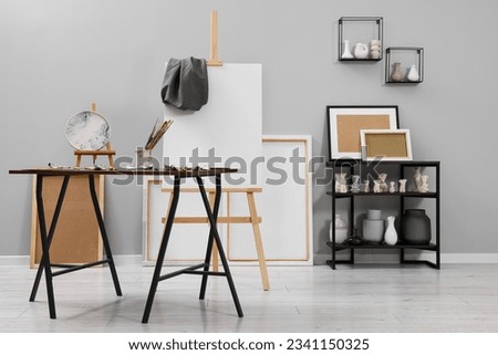 Artist's studio with easel, canvases and painting supplies