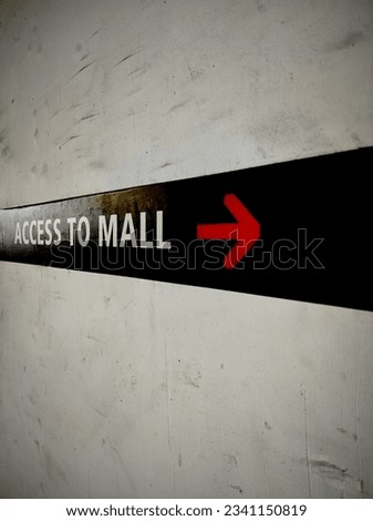 Directions to the mall attached to the car park wall in Jakarta
