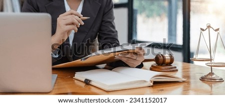Young female lawyer asian people in real estate working law book and contract documents Arguments for Defense Strategy. Fight for Freedom. Supporting Evidence