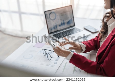 Close up of businesswoman hands using a calculator to check company finances and earnings and budget. Business woman calculating monthly expenses, managing budget, papers, loan documents, invoices Royalty-Free Stock Photo #2341152055