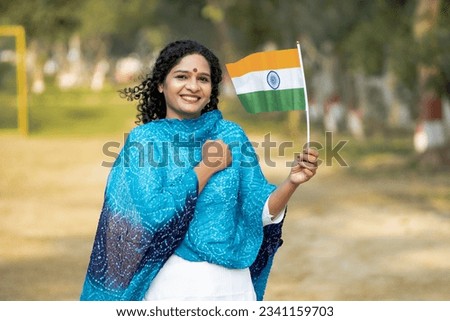 Indian woman waving national tricolor flag