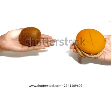 Hamburger or kiwi, fast food or healthy food, what to choose? on a white background 