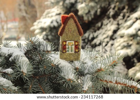 real estate, toy house on fir tree branch