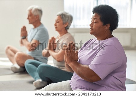 People meditating in lotus position Royalty-Free Stock Photo #2341173213