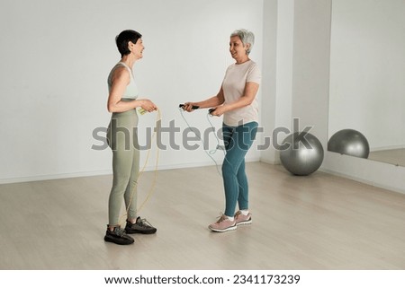 Women jumping on skipping rope Royalty-Free Stock Photo #2341173239