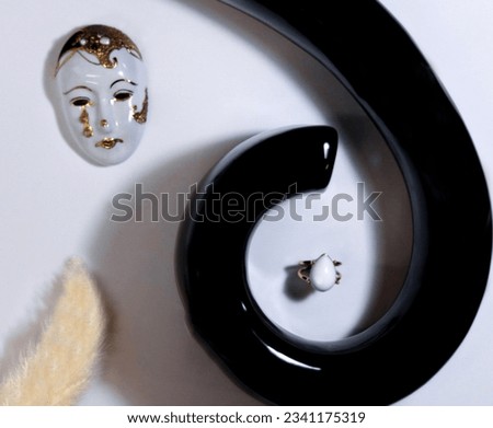 Jewellery setup. Jewelry fashion photography. Ring with a white stone displayed in Fibonacci spiral technique with Venetian mask as a prop. Advertising Photography.