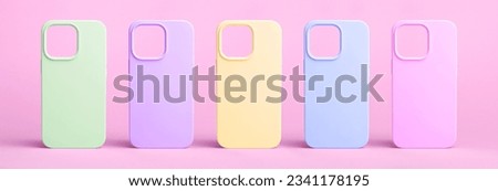 set of five back covers for mobile phone in different colors isolated on barbie pink background, phone case mock up for iPhone 15 and 14 pro max