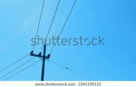 Electric pole with bright blue sky background