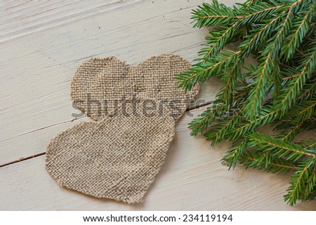 Christmas tree branch and sacking hearts   