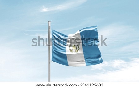 Guatemala national flag waving in beautiful sky.